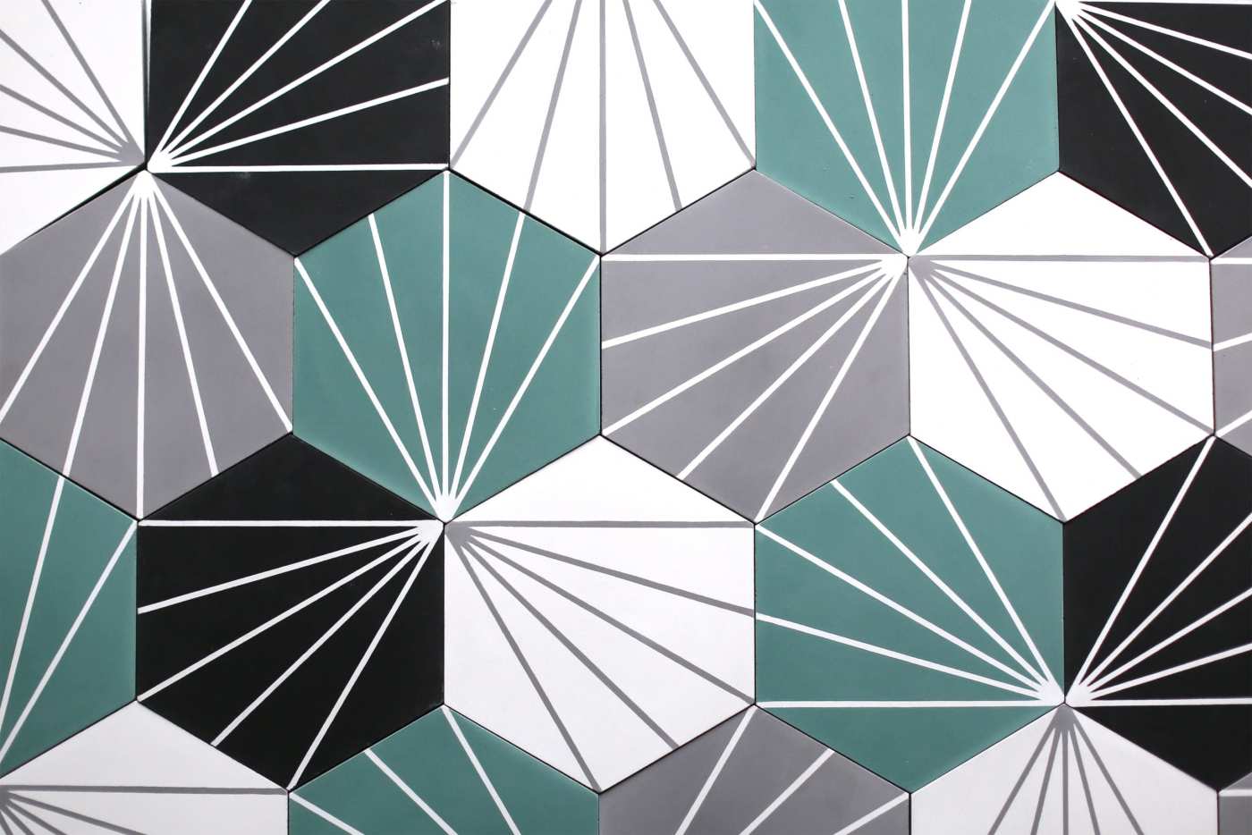 a tiled surface with teal, black, and white geometric patterns.