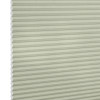 Cellular honeycomb blind, pale sage, fully lowered with visible hexagonal cells at left, blocking light; close-up product shot against a neutral white background with soft, even lighting.