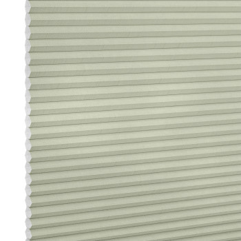 Cellular honeycomb blind, pale sage, fully lowered with visible hexagonal cells at left, blocking light; close-up product shot against a neutral white background with soft, even lighting.
