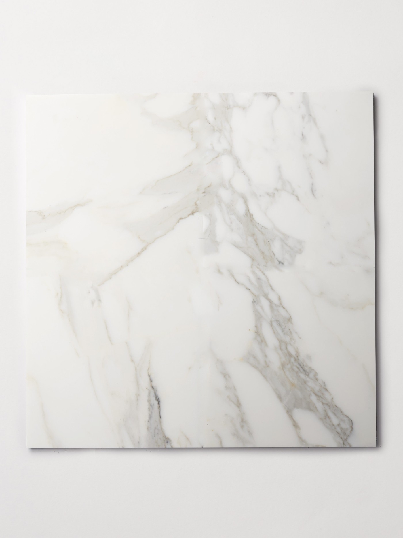 a square white marble tile on a white surface.