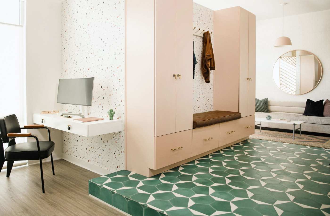 a living room with pink cabinets and green tiled floor.