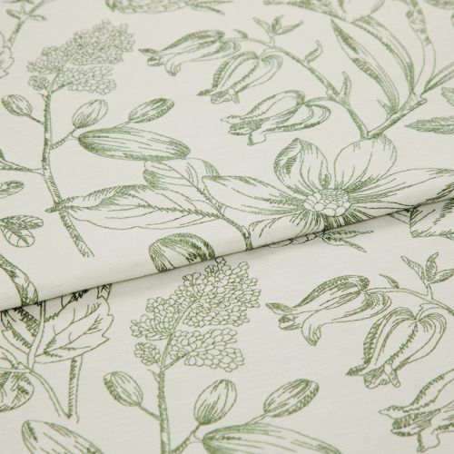 Folded curtain fabric with green line-drawn botanical print; overlapping fold reveals large floral and bud motifs, laid flat in a close-up studio view with soft, neutral lighting.