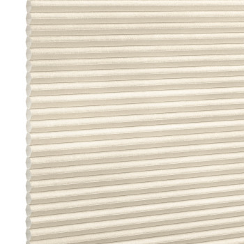 Beige honeycomb (cellular) blind, fully lowered with horizontal pleats and visible cells; closed and softly diffusing daylight; set against a neutral white-lit background with no visible room or view.