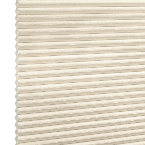 Beige honeycomb (cellular) blind, fully lowered with horizontal pleats and visible cells; closed and softly diffusing daylight; set against a neutral white-lit background with no visible room or view.