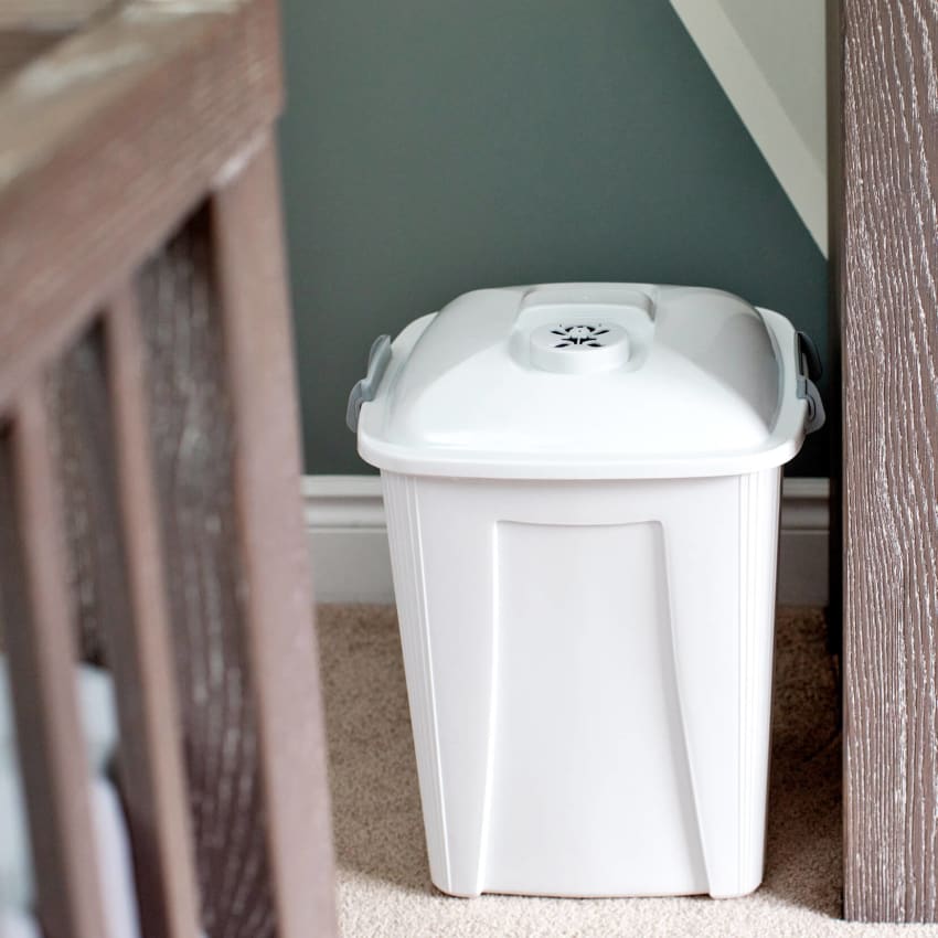 diaper bin made of durable white plastic with locking and vented lid to keep smells inside
