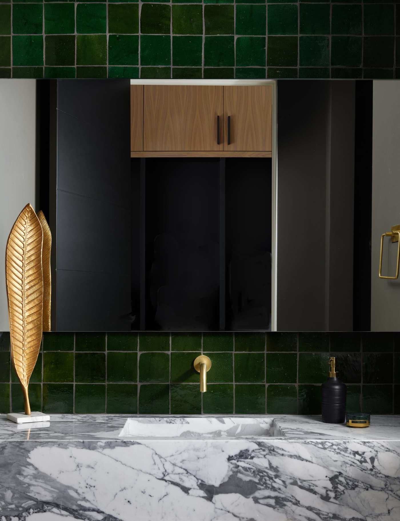 a bathroom with green backsplash tiles.