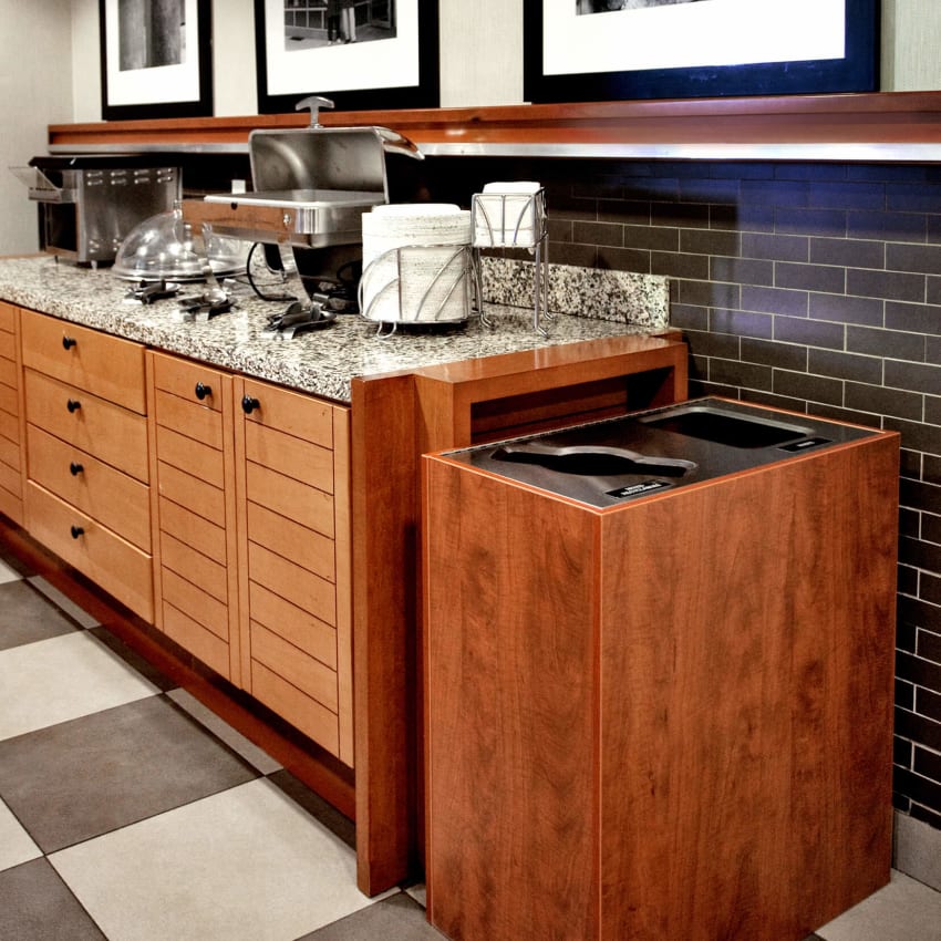 modern recycling and waste bin in a hotel breakfast area shown in a cedar wood texture