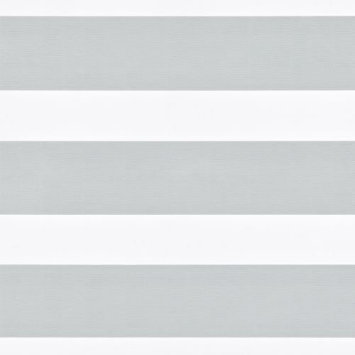 Horizontal-striped zebra roller blind, lowered across the window with alternating light-gray sheer and white opaque bands; diffusing and partially blocking daylight, set against a neutral, minimally detailed interior.