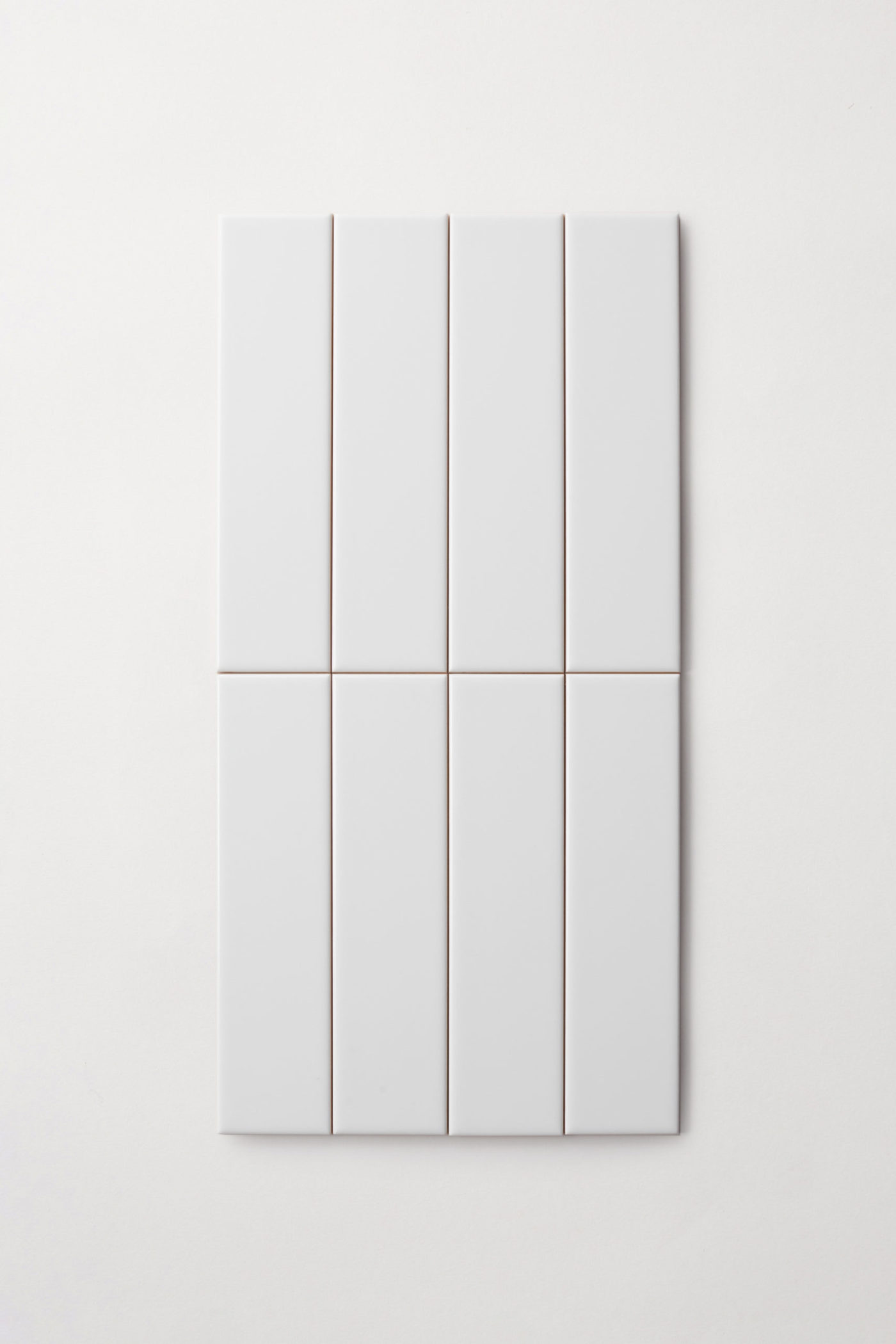 a set of white rectangle tiles on a white surface.