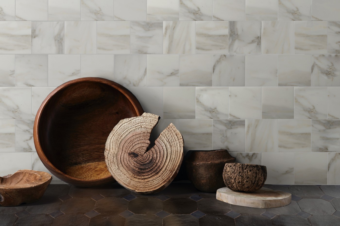 a marble tile wall with wooden bowls.