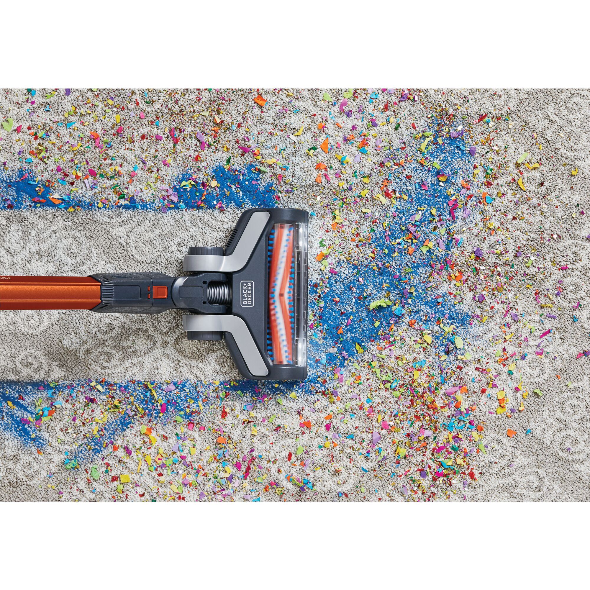 POWER SERIES Extreme Cordless Stick Vacuum Cleaner being used to clean confetti and party favours from carpet.