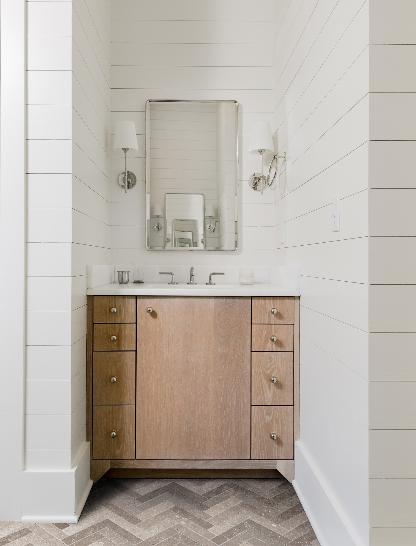 a bathroom with a mirror and sink.