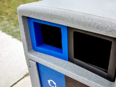 closeup view of the canopy lid on a waste and recycling container made from durable LDPE plastic sitting outside on a city sidewalk