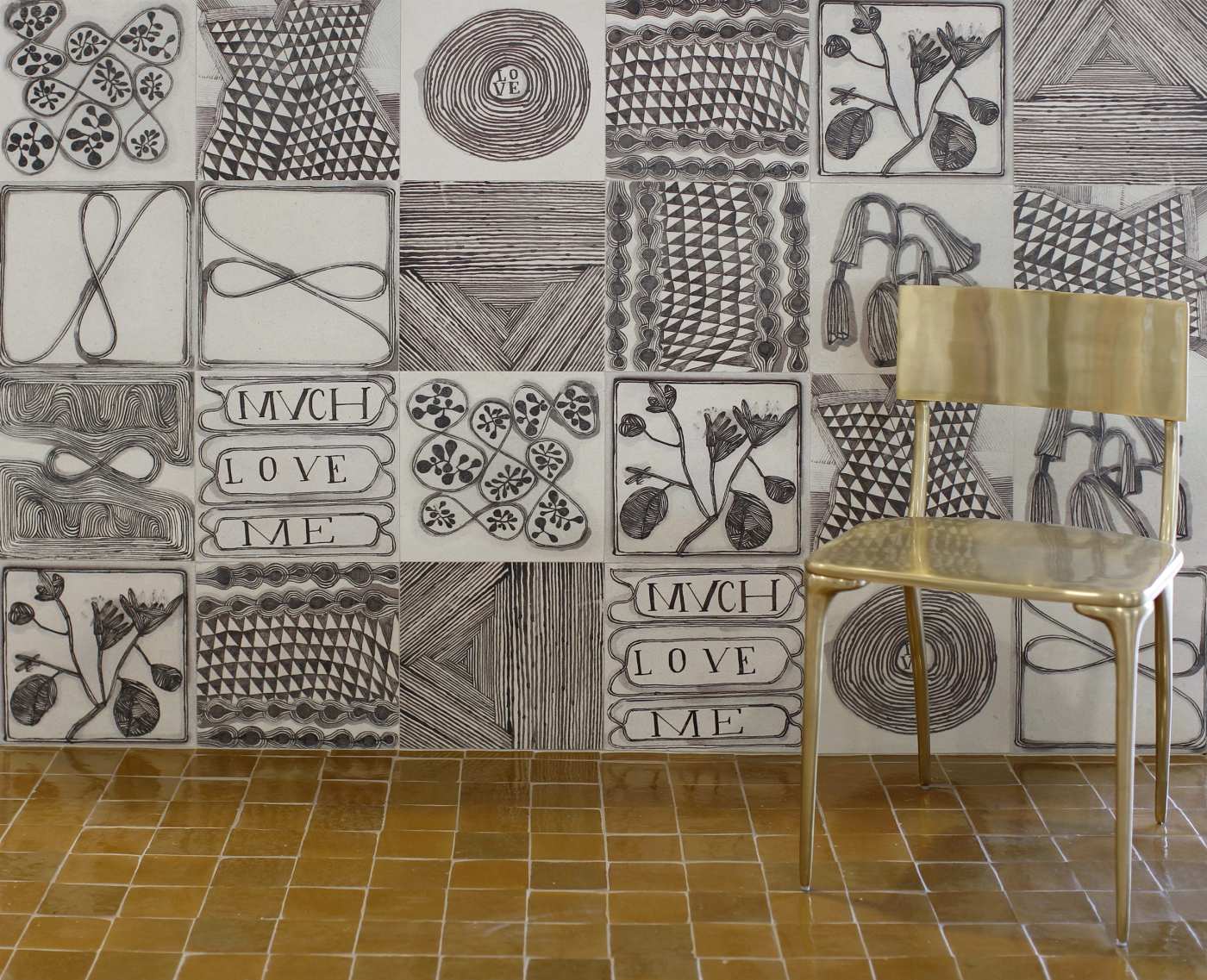 a chair in front of a patterned tile wall.