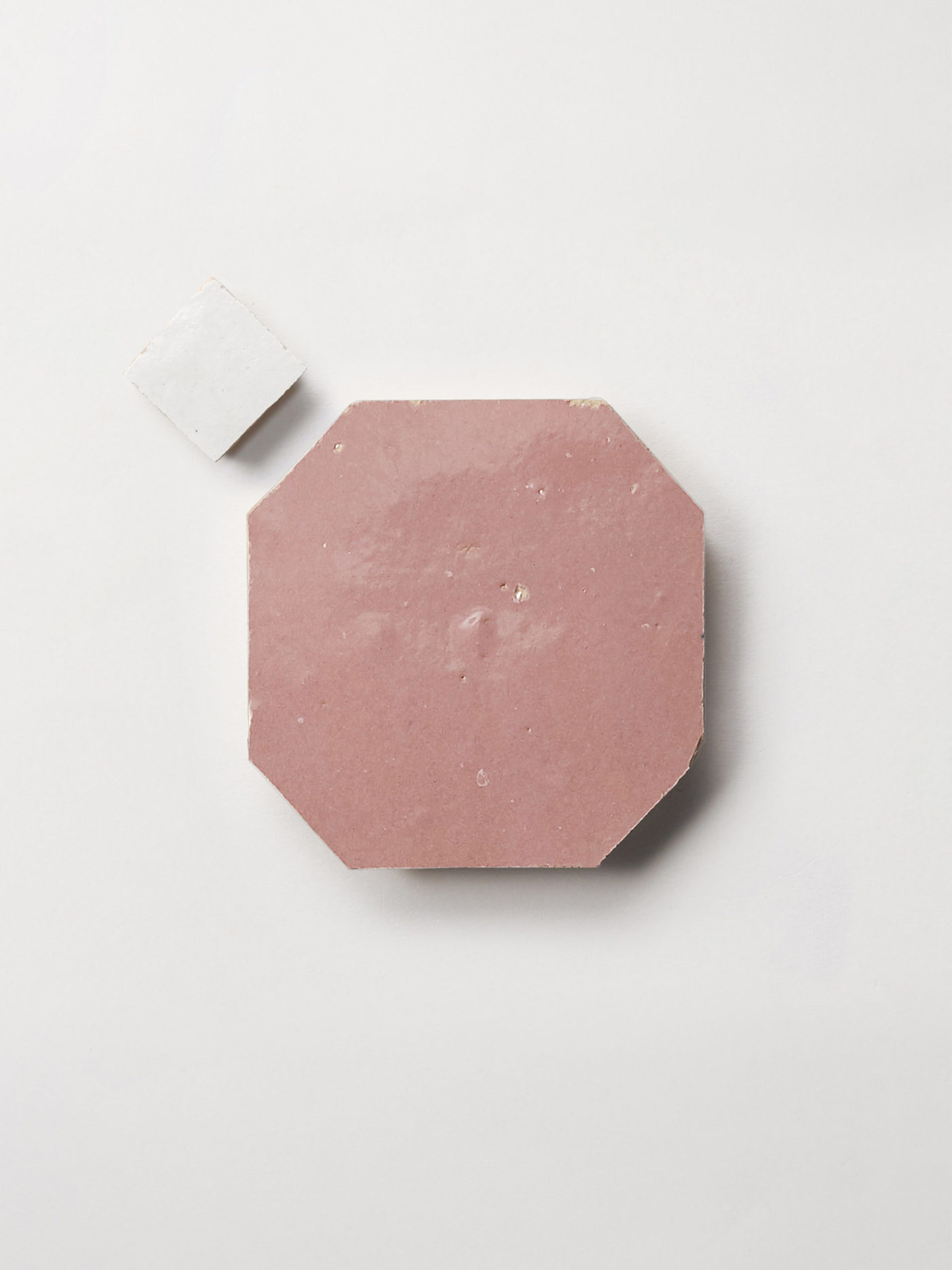 pink and white tiles on a white surface.