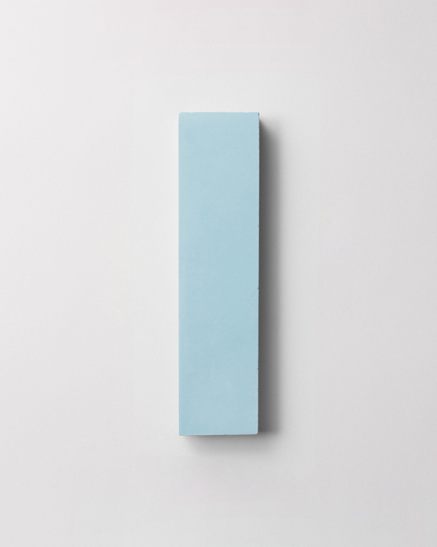 a light blue rectangle tile on a white surface.