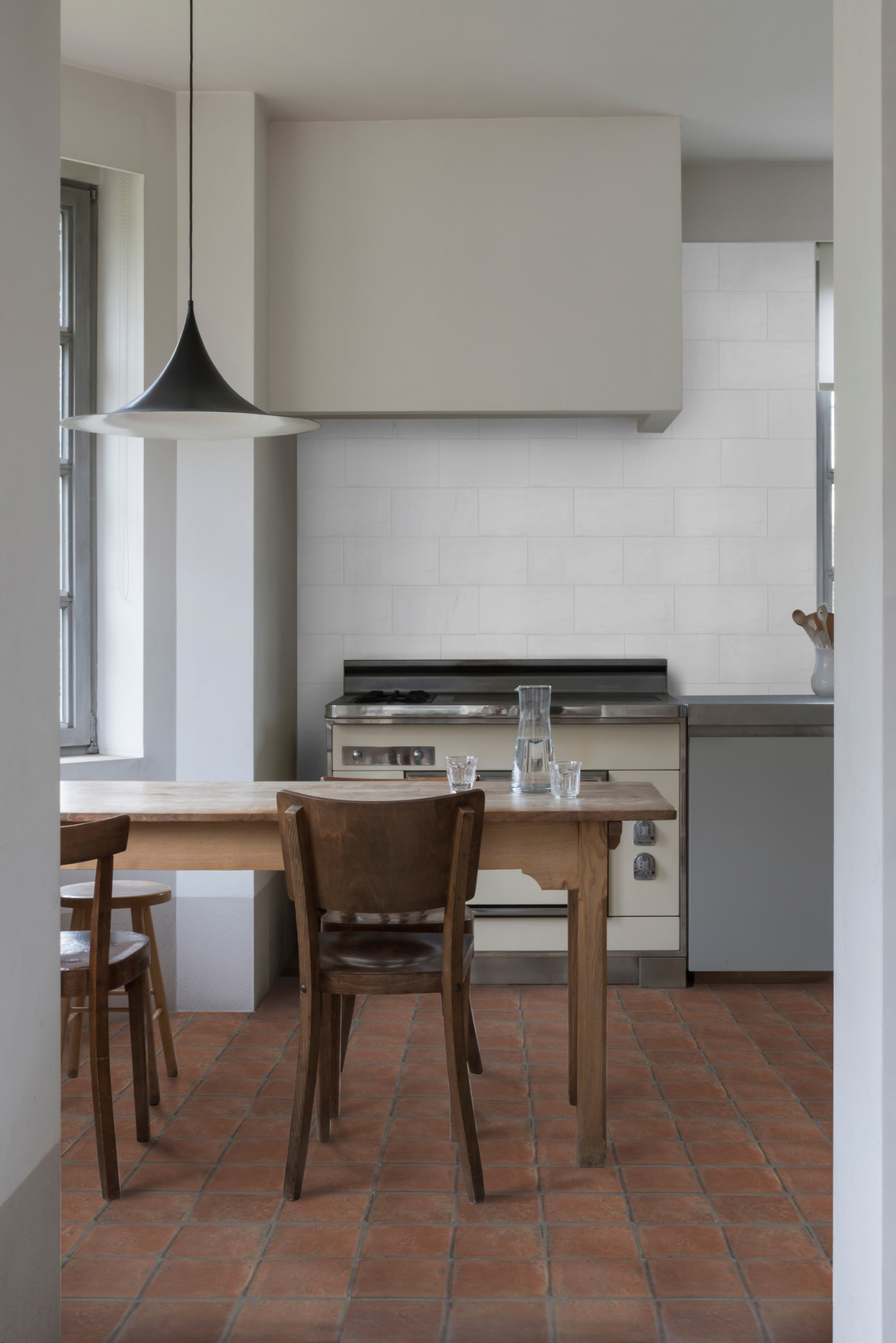 a kitchen with a wooden table and chairs.