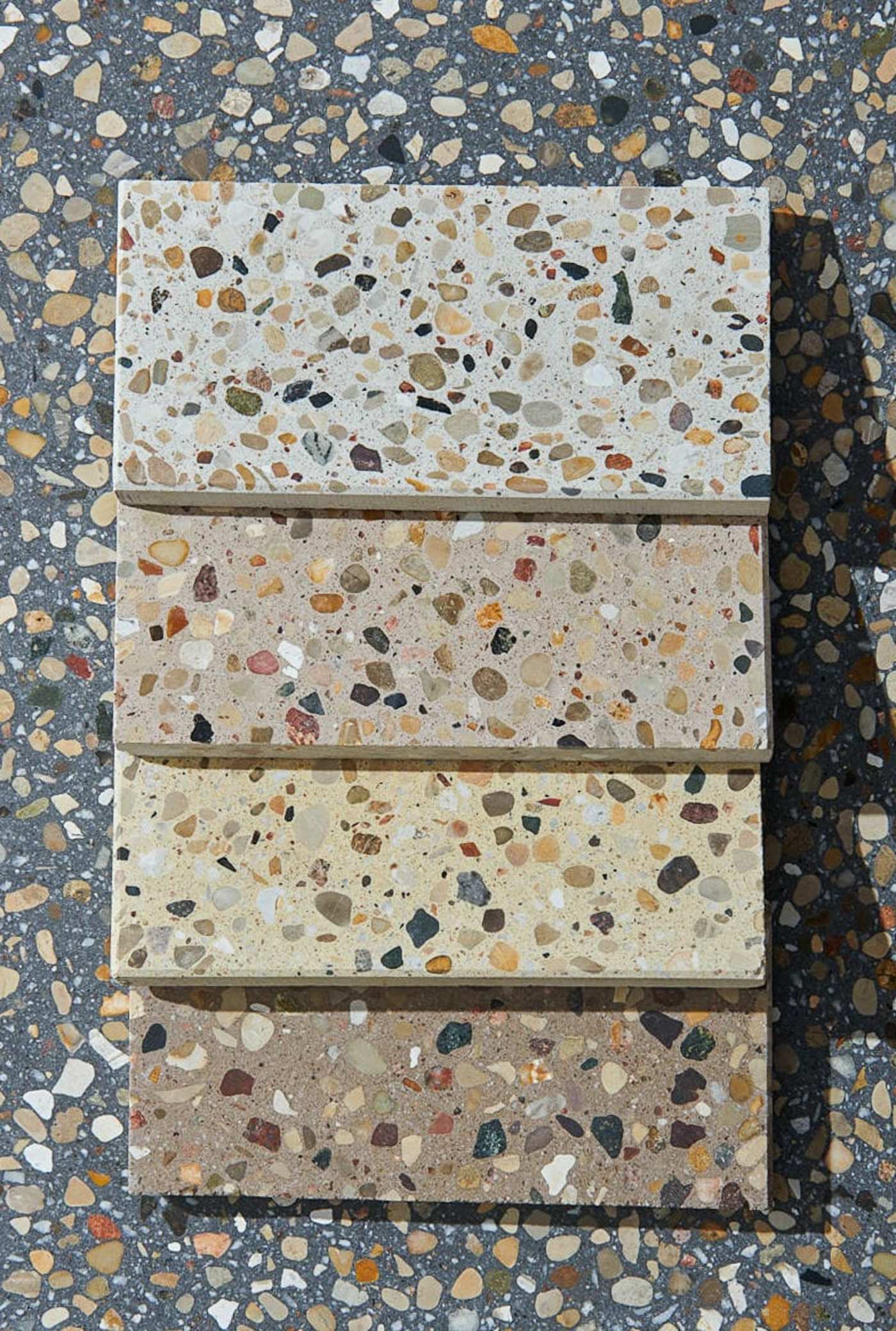 a row of different colored rectangle tiles with terrazzo patterns.