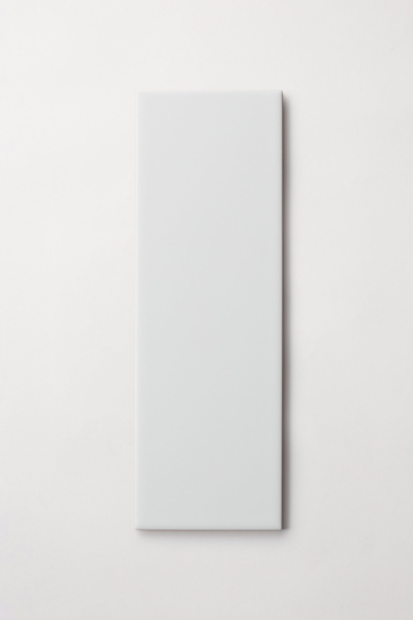 a white rectangle tile on a white surface.