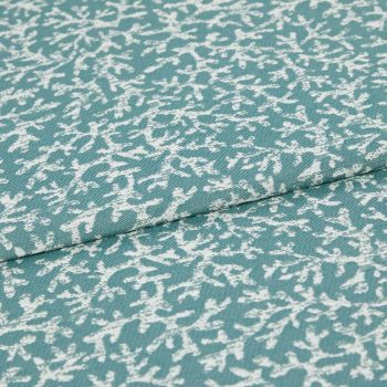 Woven teal upholstery fabric with irregular white abstract print; folded along a seam, lying flat; close-up studio view showing texture and weave.