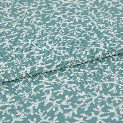 Woven teal upholstery fabric with irregular white abstract print; folded along a seam, lying flat; close-up studio view showing texture and weave.