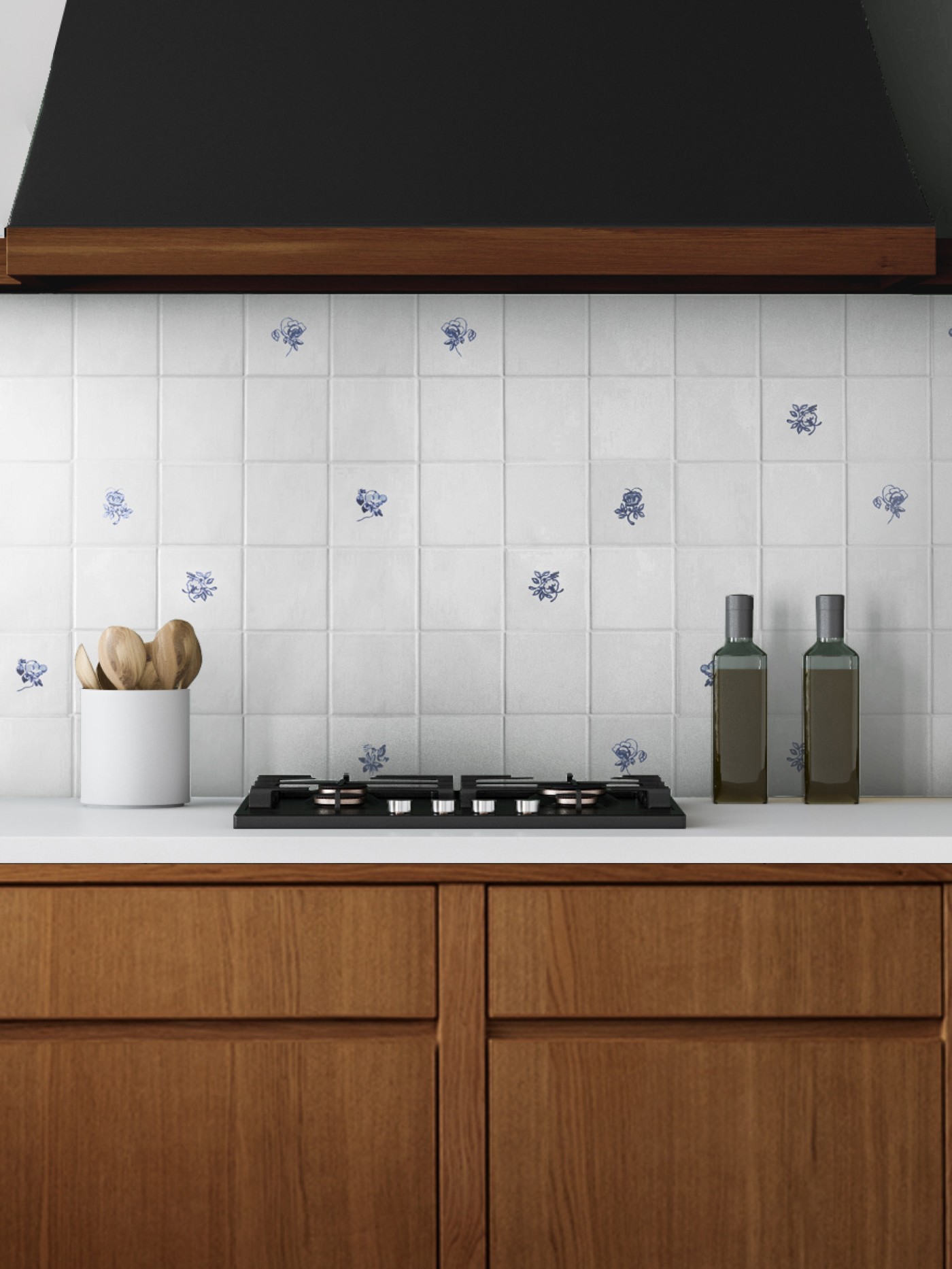 a blue and white tiled stove backsplash in a kitchen with wooden cabinets.