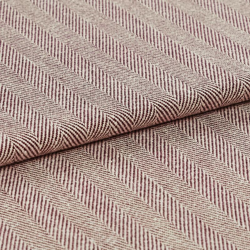 Woven upholstery fabric with beige-and-burgundy diagonal herringbone stripes and ribbed texture; folded and overlapped to reveal the pattern repeat; close-up, evenly lit studio setting.
