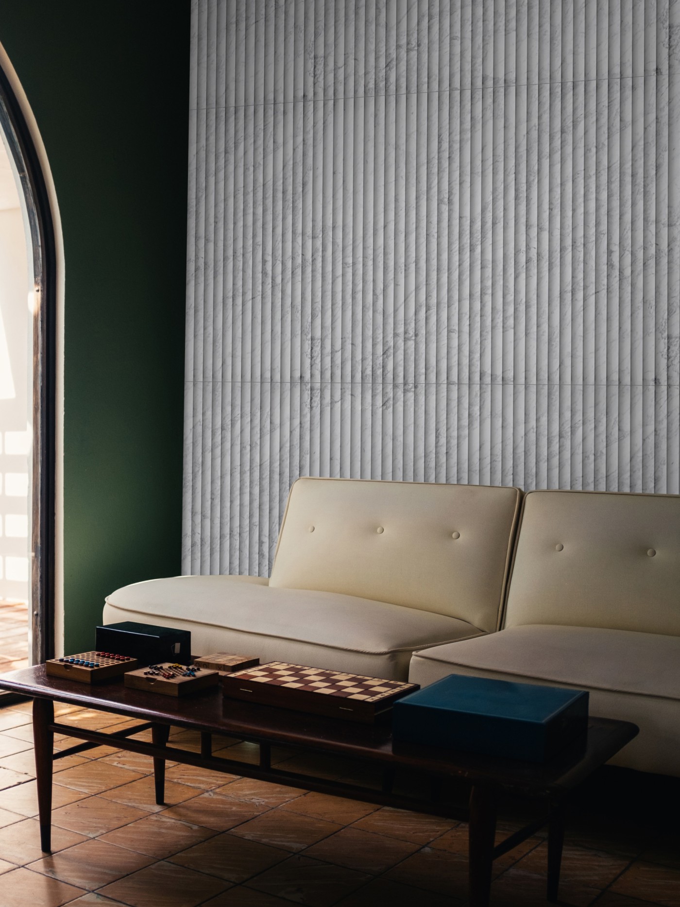 a living room with a vertical tile wall, couch, and coffee table.