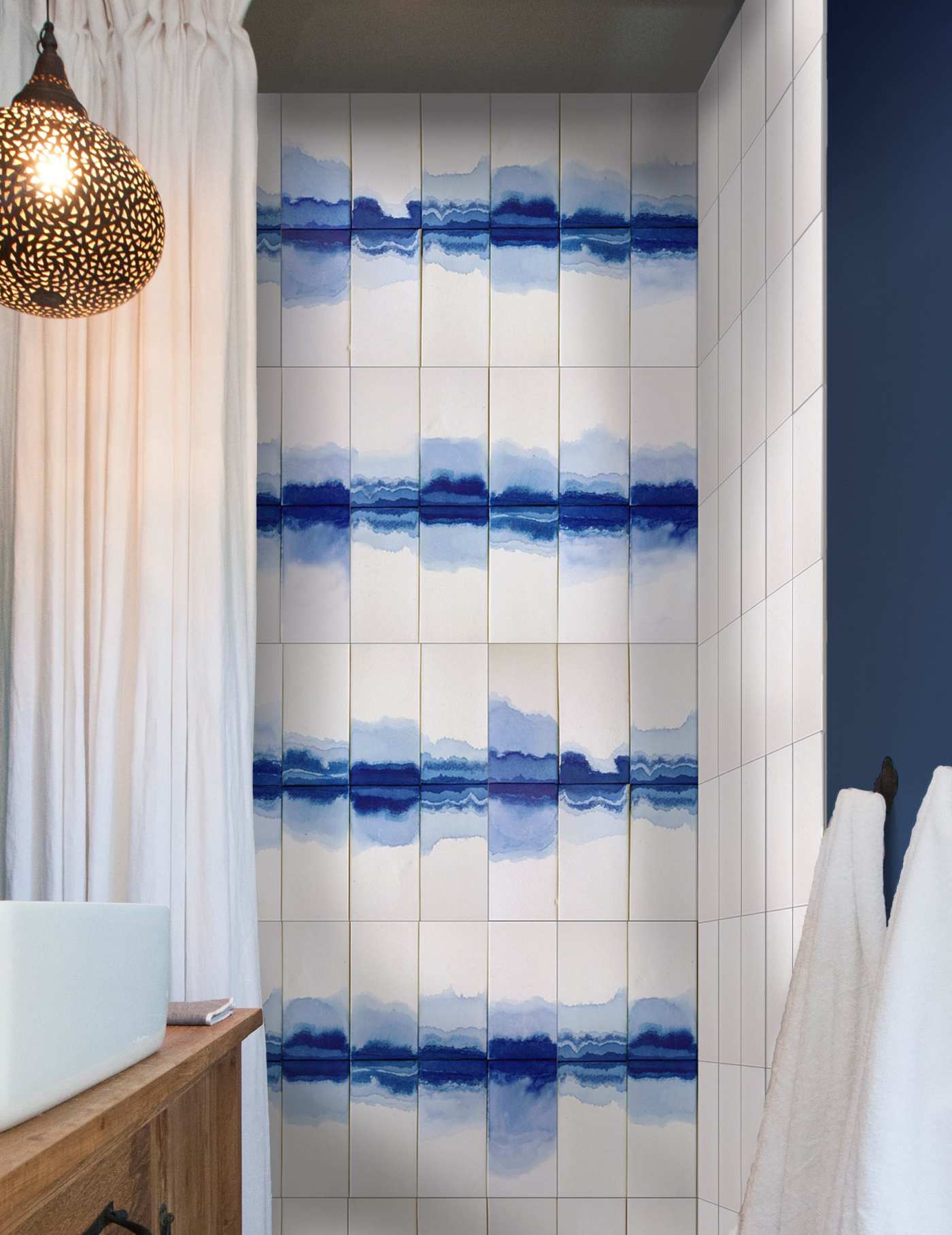 a bathroom with a blue and white tiled wall.