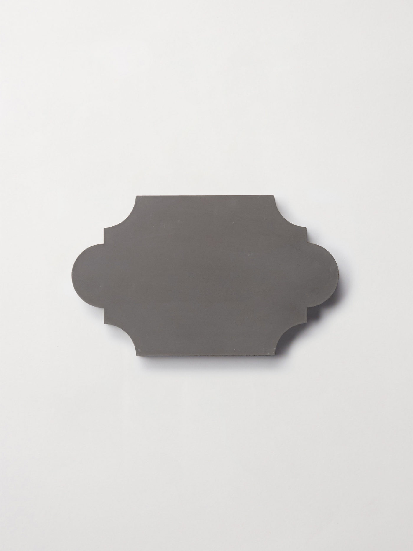 a black lantern-shaped tile on a white surface.