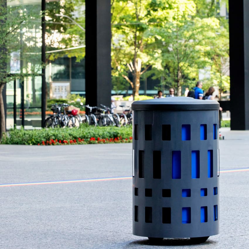 steel powder coated body with durable LDPE plastic liner and domed canopy lid in an outdoor municipal park area