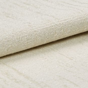 A folded beige woven fabric with subtle sheen and raised grid texture, layered over matching fabric; close-up studio view with soft, diffuse lighting on a neutral surface.