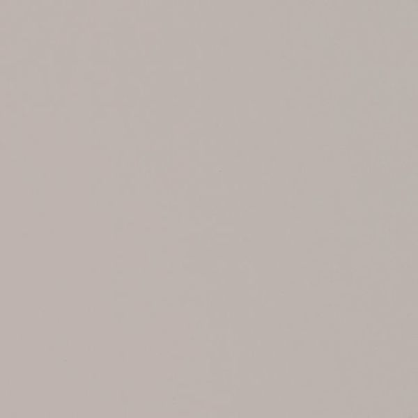 Plain pale beige wall fills the frame, uniformly lit and featureless, showing subtle texture under soft diffuse light in a minimal indoor scene.