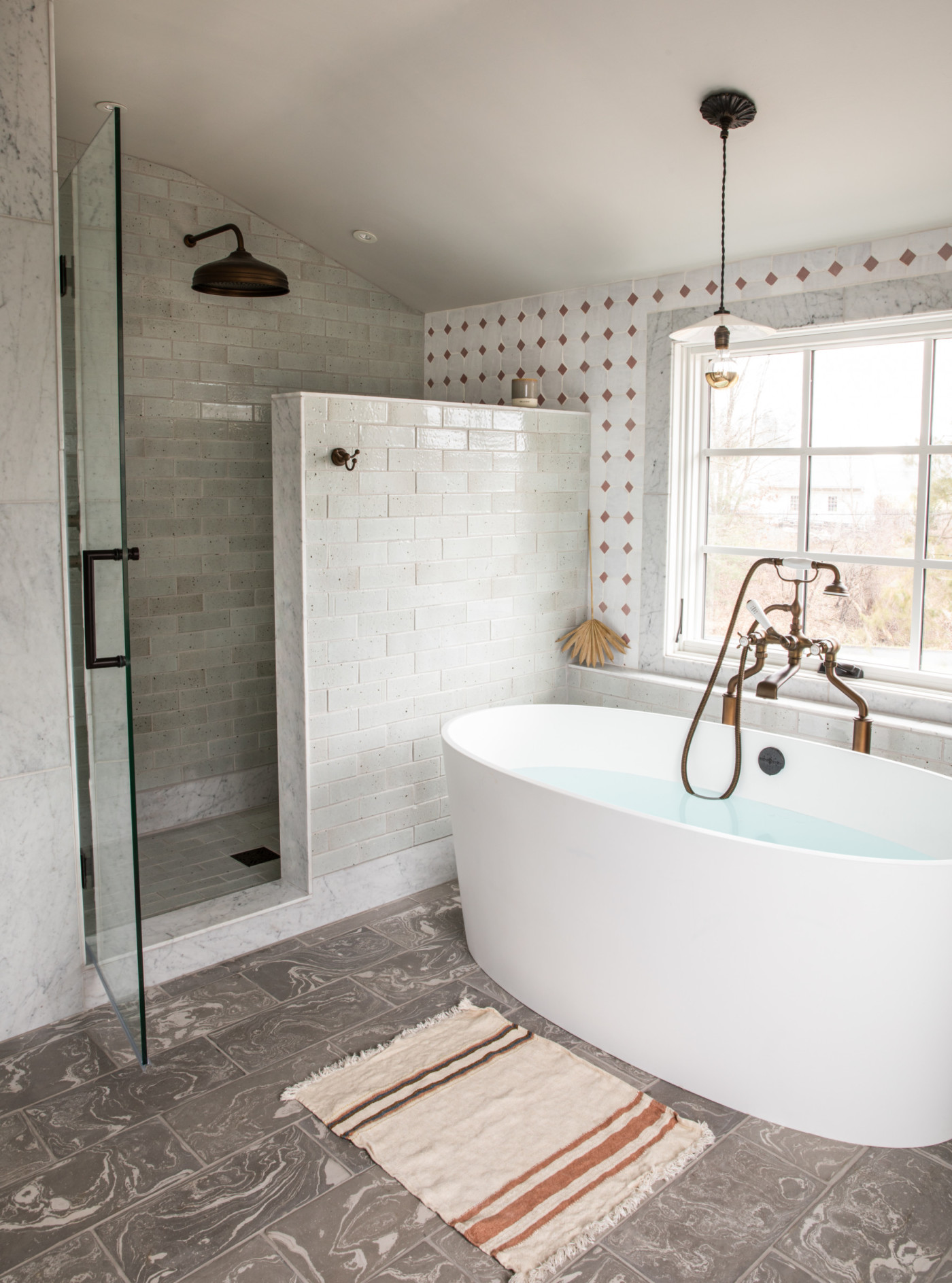 a bathroom with a large tub and a shower.