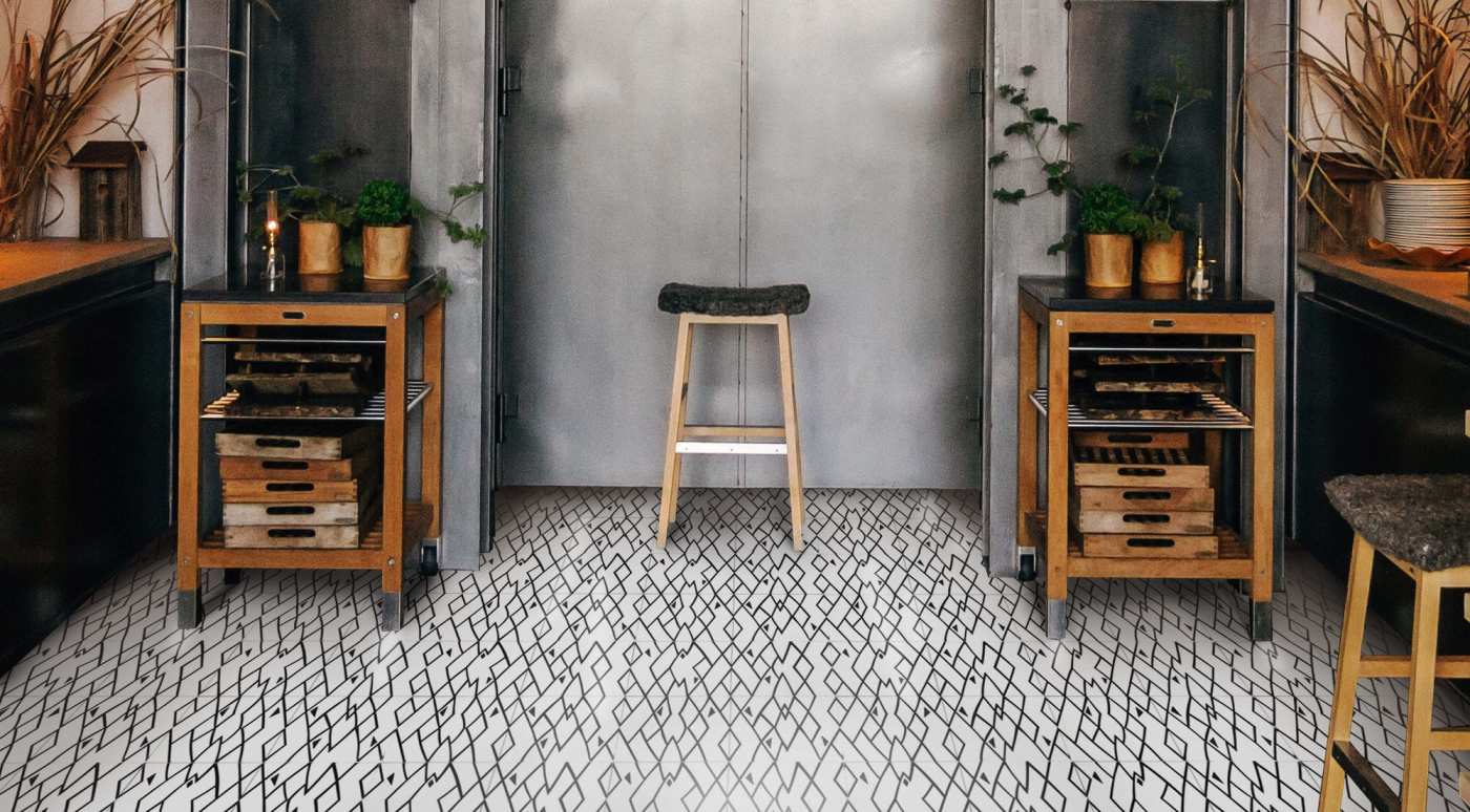 a black and white tiled floor in a kitchen.