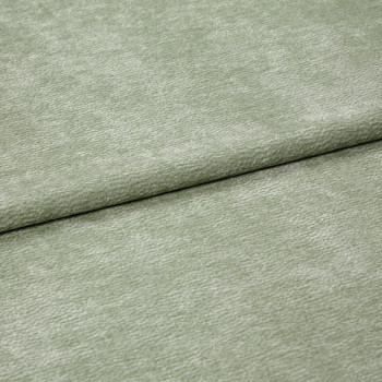 Velvet-like pale sage-green fabric folded horizontally, creating an overlapping seam; soft, short-pile texture; close-up, evenly lit studio view filling the frame.