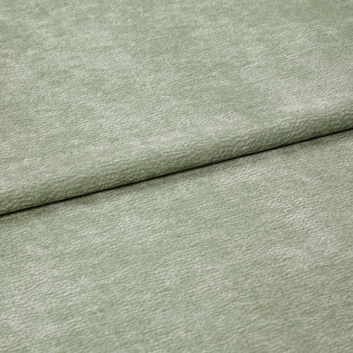 Velvet-like pale sage-green fabric folded horizontally, creating an overlapping seam; soft, short-pile texture; close-up, evenly lit studio view filling the frame.