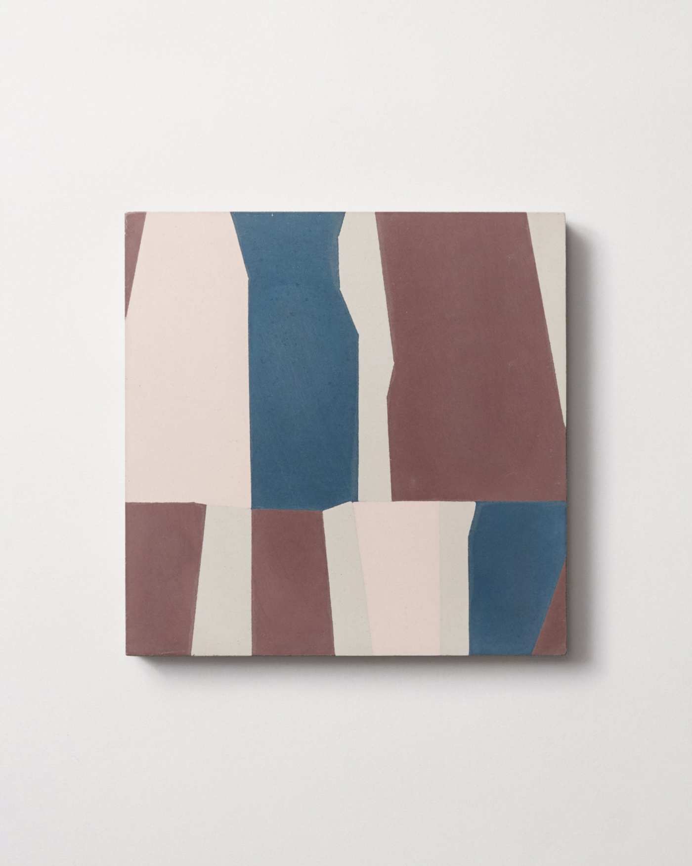 a blue, pink, and brown tile on a white background.