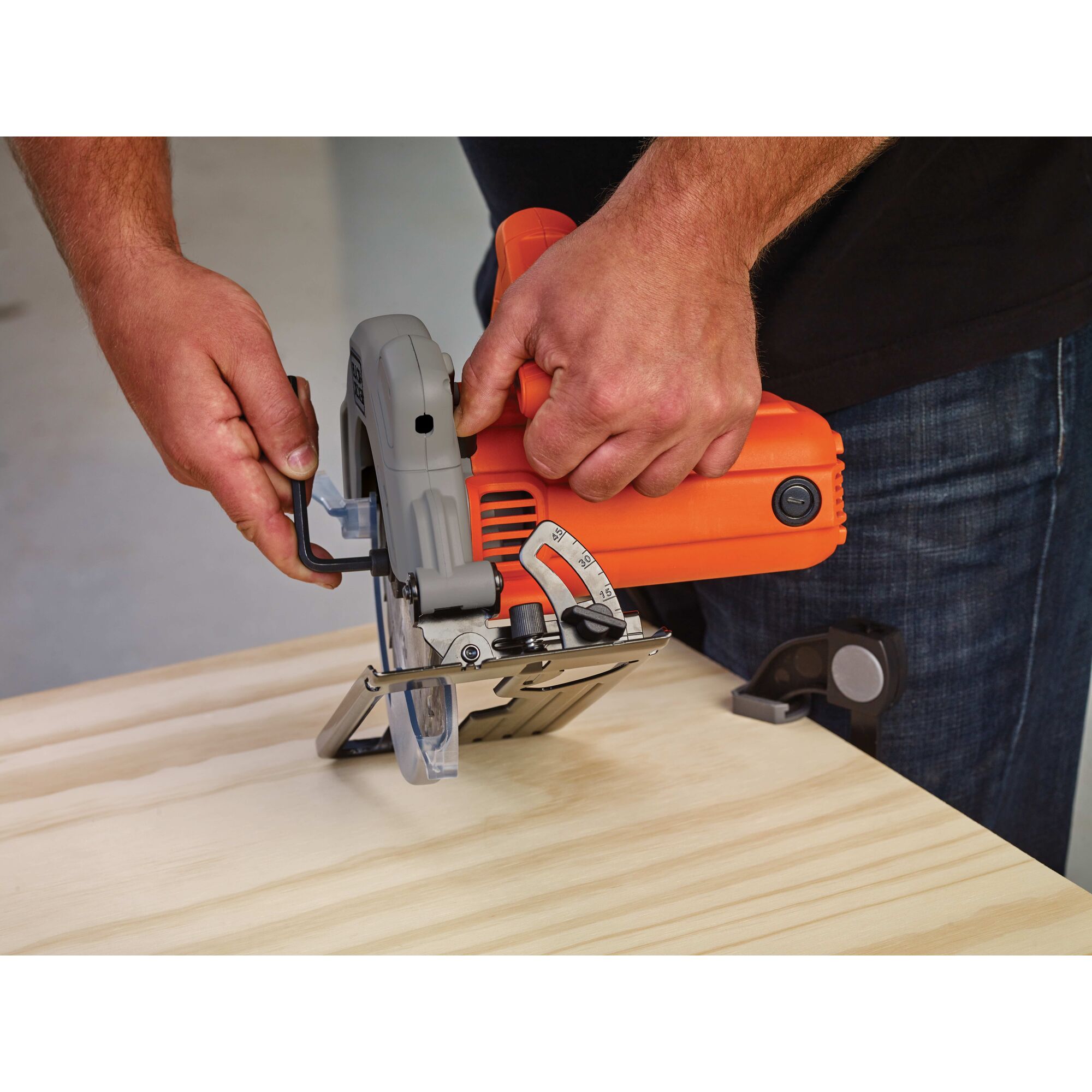 Person using black and decker 7-1/4-Inch Circular Saw With Laser, 13-Amp to cut wooden material