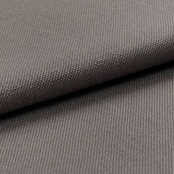 Gray woven fabric (canvas-like), folded diagonally over itself, showing dense pebble and twill textures; soft, even studio lighting highlights fine weave in a close-up, neutral setting.