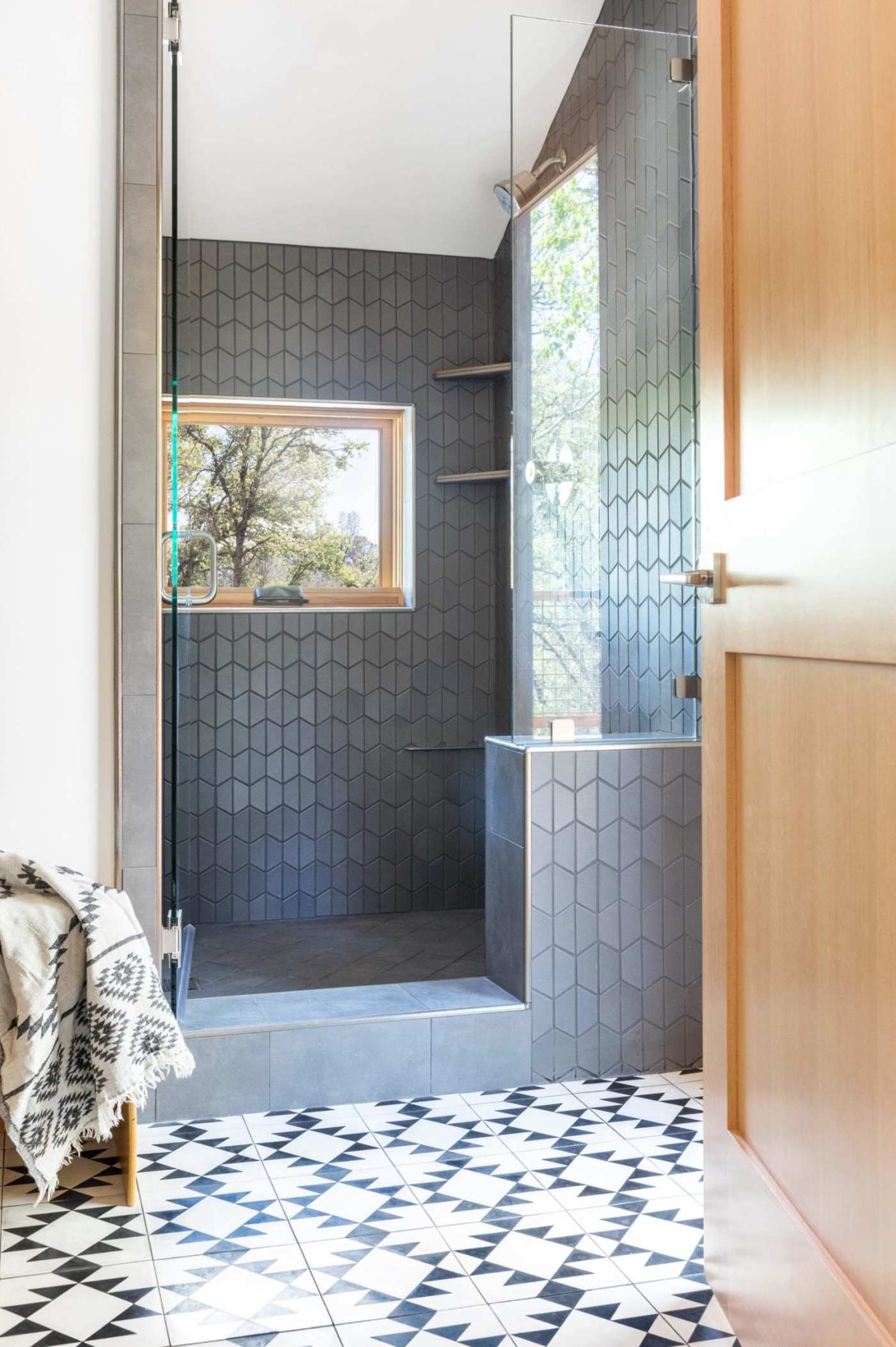 a bathroom with a black and white tiled floor.