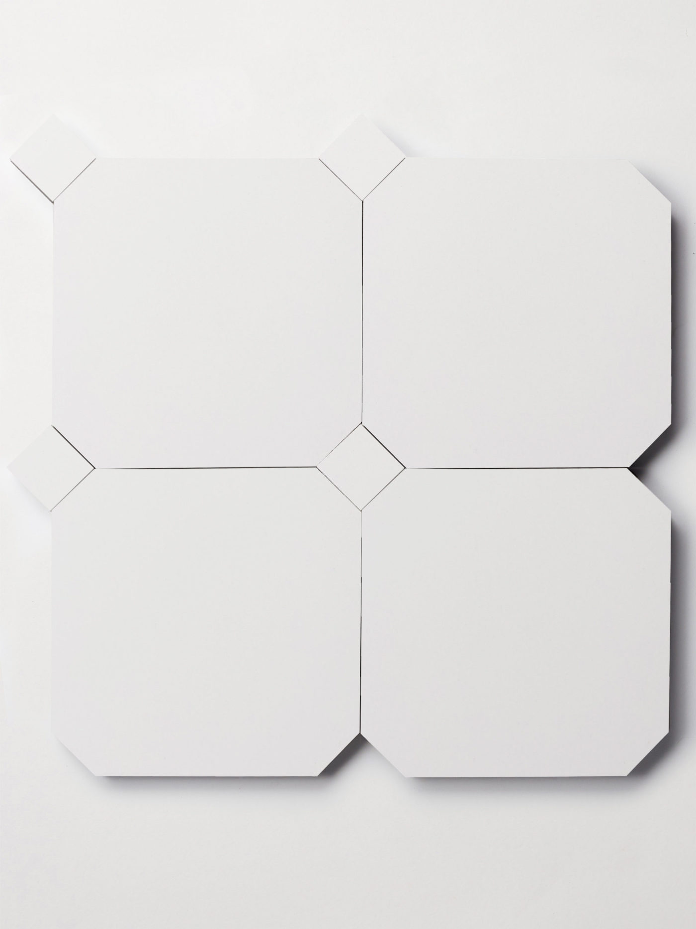 a set of white tiles on a white surface.