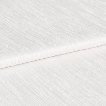White ribbed textured fabric, folded in overlapping layers showing subtle horizontal sheen; lying stacked on itself, photographed in close-up under soft, even studio lighting with a neutral background.