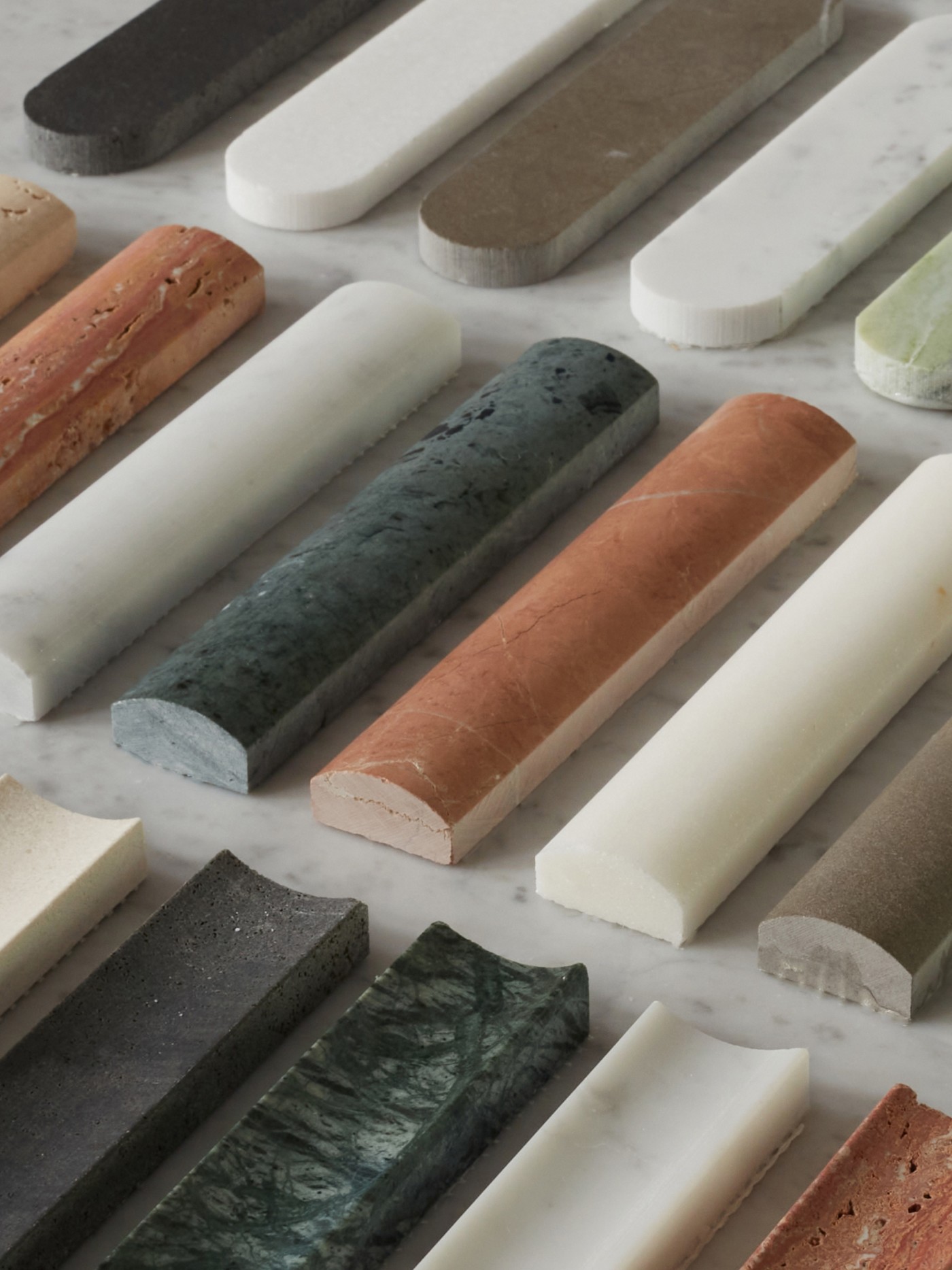 a variety of different colored marble slabs on a table.