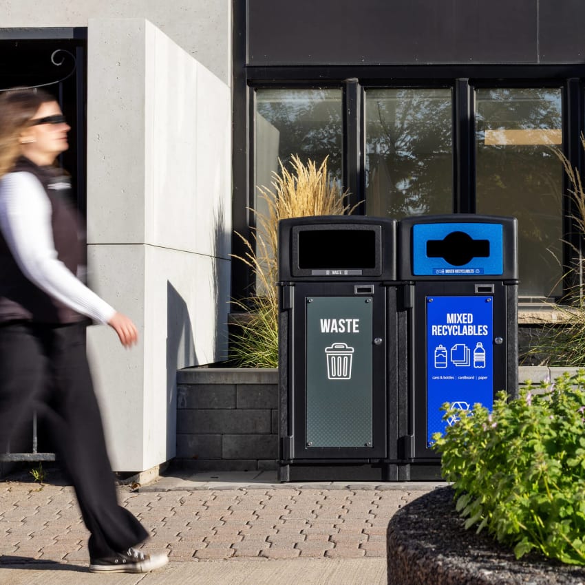 large capacity outdoor double waste and recycling bin with restrictive openings and large door signs for improved waste diversion