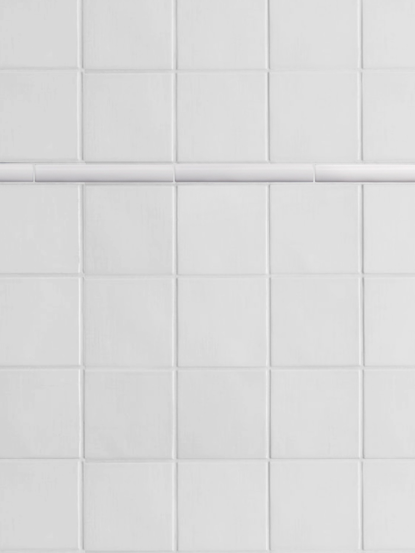 a close up of a white tiled wall.