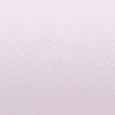 Pale pink, lightly stippled wall surface displaying a subtle textured finish; uniformly lit and filling the frame, with no visible fixtures or furniture, suggesting a neutral, minimal interior background.