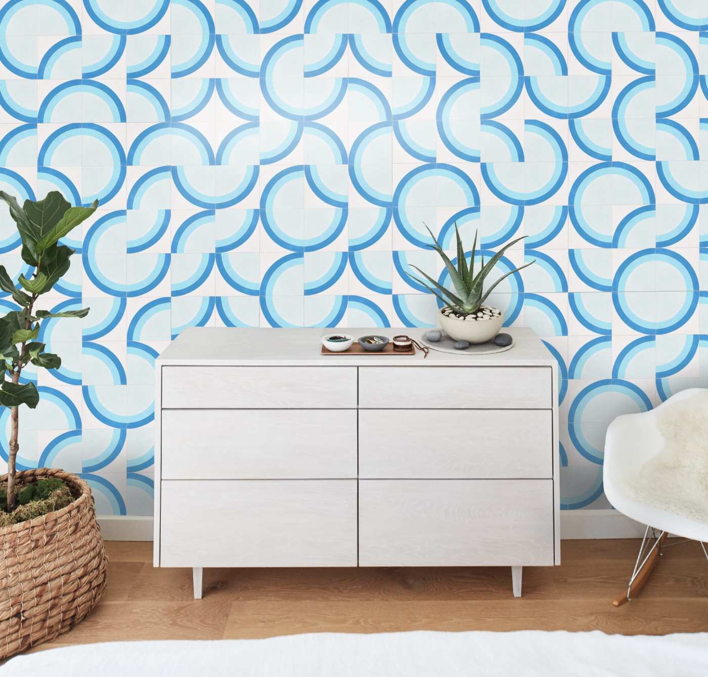 a bedroom with a blue and white tiled wall.