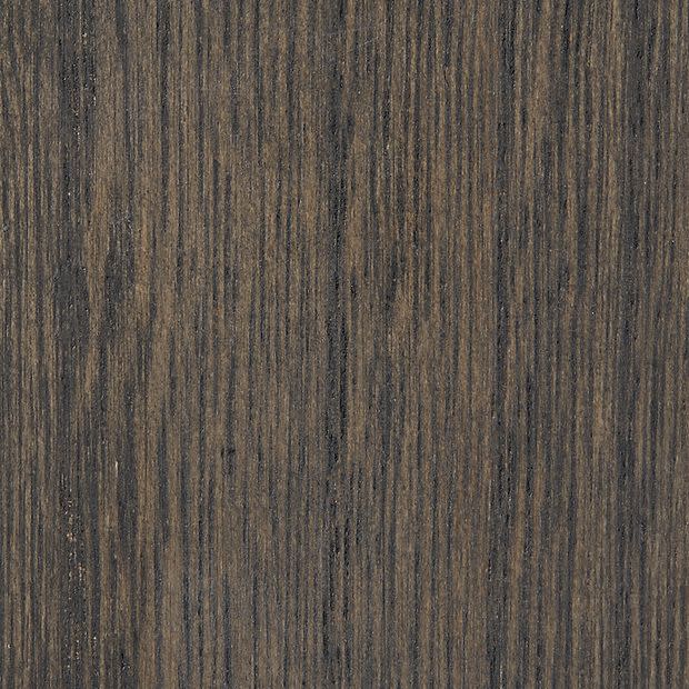 Dark wood veneer panel with fine vertical grain patterns; stationary, displaying subtle bark-like striations; close-up view under even lighting, likely a tabletop or cabinetry surface.