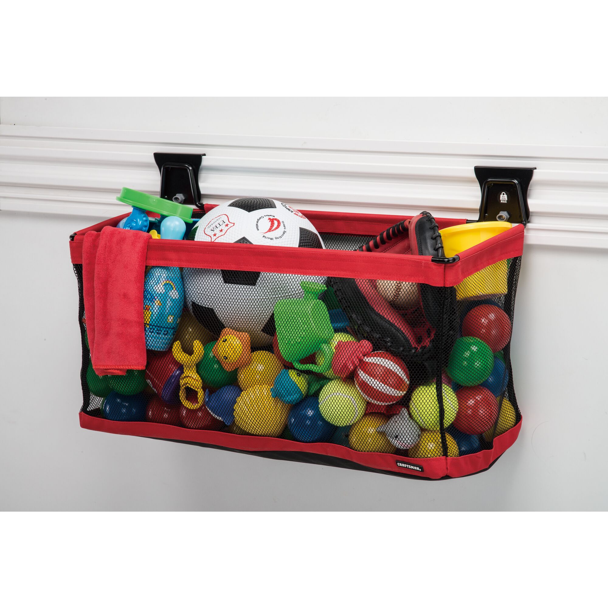 Black and red VERSATRACK 24 inch large mesh basket attached to white VERSATRACK trackwall filled with assorted childen's toys and sports balls